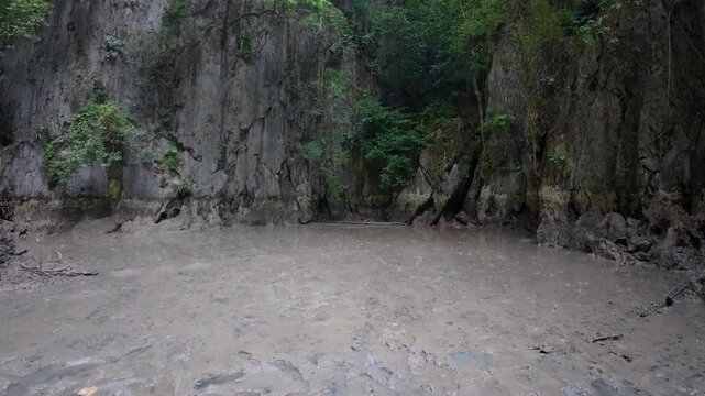 Panak İsland , a peaceful sandy beach surrounded by cliffs and greenery, with smooth sand and no visible footprints or human presence 