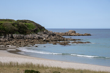 Atlantic coastline at Praia de Lourido, Muxía, Galicia, Spain. Panoramic beach view featuring soft dunes, calm sea, and a green pathway leading to the shore.
