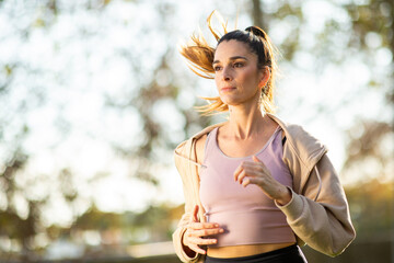 Young woman jogging with focus and determination