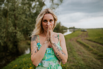 Joyful Blonde Woman in Nature – Smiling and Expressive by the Riverside