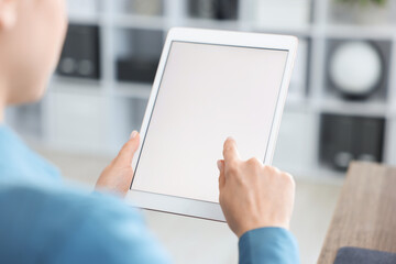 Woman with modern tablet indoors, closeup view