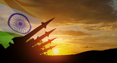 The missiles are aimed at the sky at sunset with Indian flag. Nuclear bomb, chemical weapons, missile defense.