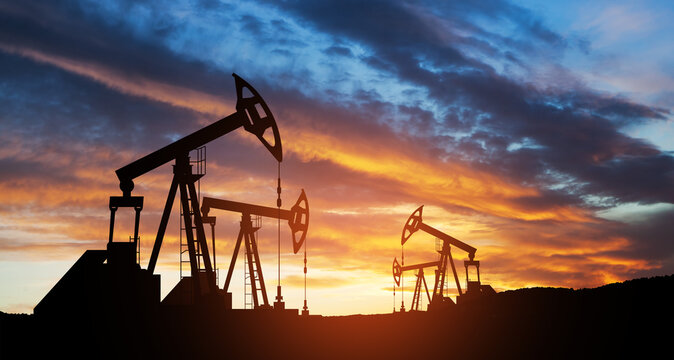 Oil drilling derricks at desert oilfield. The change in oil prices caused by the war. Oil price cap concept. - Powered by Adobe