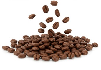 Naklejka premium Falling coffee beans creating a pile of roasted beans on a white surface in a studio shot