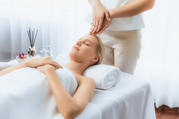 Caucasian woman enjoying relaxing anti-stress head massage and pampering facial beauty skin...