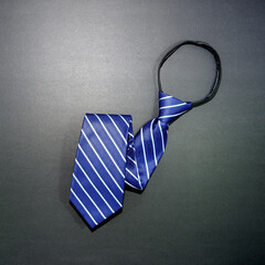 A blue zipper tie folded on dark background closeup shot 