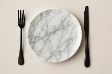 Dessert plate in marble print with black cutlery. Top view