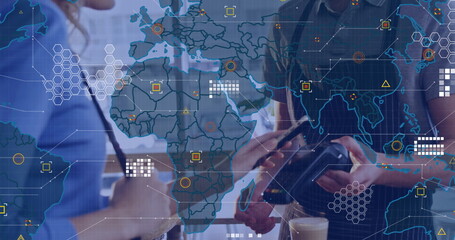 Image of world map over people using payment terminal