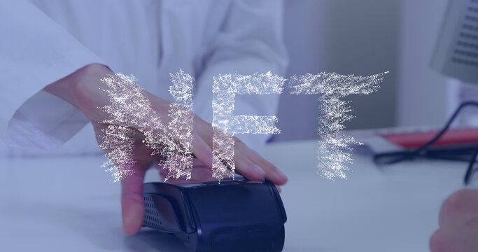 Image of nft text banner over mid section of man making a payment by his credit card