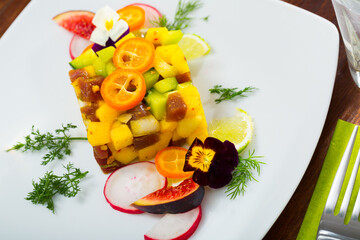 Image of deliciously tartar of raw tuna with avocado, mango and greens