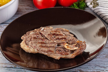 Grilled lamb steak with bone