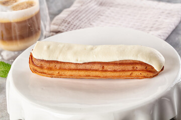 White vanilla eclair with icing