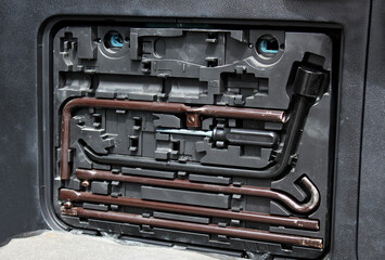 A set of necessary tools in the door of an premium SUV