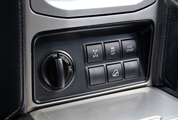 Fototapeta premium Off-road control panel. Off-road driving mode switch. Control of locks, drive and low gear. 2wd and 4wd button in the off-road. Off-road 4x4 transmission handle