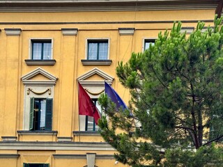 view of an official building in Tirana with flags
