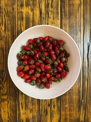 Fresh Strawberries in White Bowl on Rustic Wooden Table
