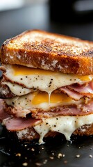Delicious toasted ham and cheese sandwich dripping melted cheese