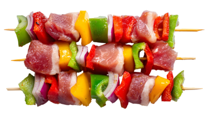 A plate of meat and vegetables with skewers on it