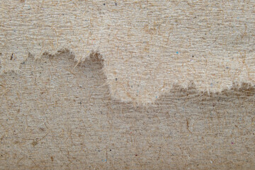 Close-Up of Torn Textured Brown Fiber Paper Showing Raw Edge