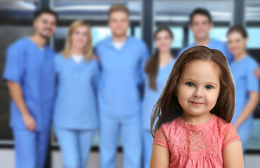 Obraz premium Cute child and medical staff in hospital. Pediatric ward