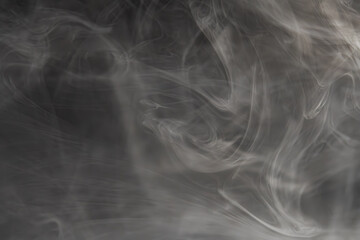 Image depicts a dark scene with smoke emanating from bottom right, representing mystery or transition