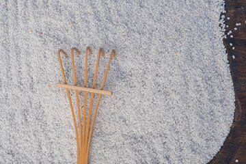 A diagonal arrangement of wooden chopsticks on white rice, hinting at an Asian-inspired setting