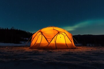 Illuminated orange tent set against a stunning sky featuring the northern lights in a wint
