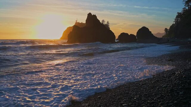 Strong Waves of the Pacific Ocean crash against the shore at Ruby Beach during sunset in Olympic National Park, Washington, USA. 4K UHD video.