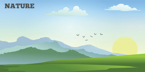 Obraz premium a landscape with green hills and mountain silhouettes. The sun is setting or rising, the sky is in soft blue and yellow shades with white clouds. A flock of birds can be seen in the sky