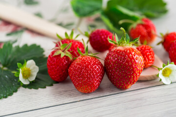 Ripe strawberries on a light wooden table