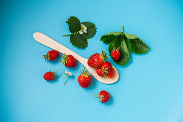 Ripe strawberries on a stylish blue surface