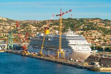 Cruise Ship Docked at Industrial Port with Cranes. Marseille, France