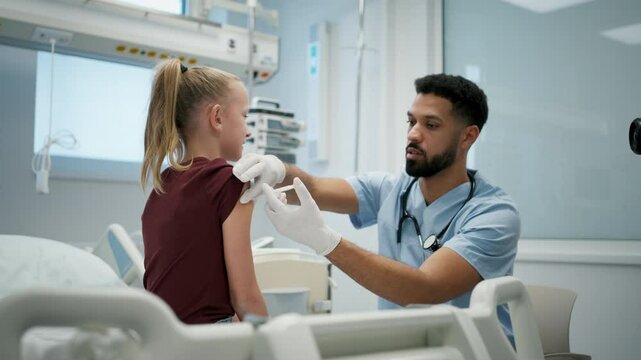 Doctor giving vaccine to young girl during childhood immunization.