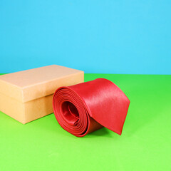 A red tie rolled with gift box closeup shot 