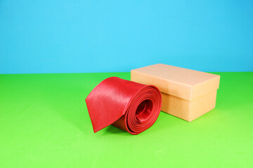 A red tie rolled with gift box closeup shot 