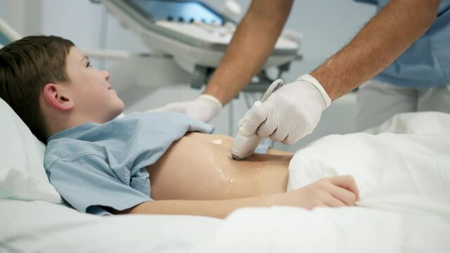 Doctor using ultrasound probe to check on young boy, abdominal ultrasound.