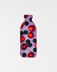 Summer layout with red cherries and blueberries visible through a bottle shaped gap on purple...