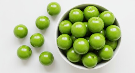 Top View of Unripe Green Plums on White Background