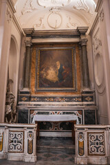 An intricately designed altar in an Amalfi church, featuring a Nativity painting, marble columns,...