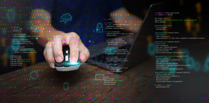 Digital technology and cloud computing: concept. A man using a mouse and laptop to create, store, process, and communicate information as data represented in binary code