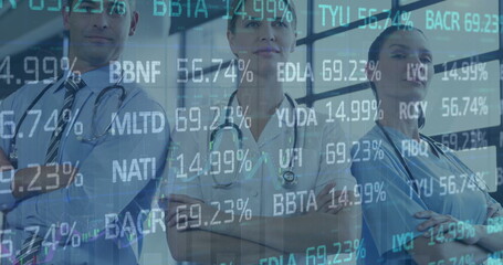 Image of stock market data processing over team of diverse medical health workers standing