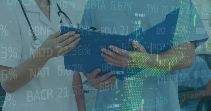 Image of stock market data processing over female doctor and health worker examining reports