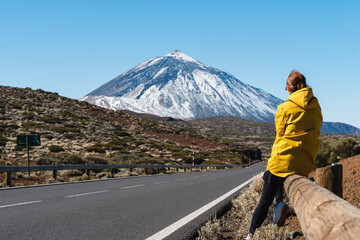 Woman enjoying the view of Teide volcano, El Teide National Park, Tenerife, Canary Islands, Spain.