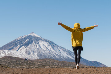 Woman enjoying the view of Teide volcano, El Teide National Park, Tenerife, Canary Islands, Spain.