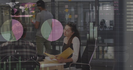 Statistical data processing against diverse male and female office colleagues discussing at office