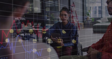 Statistical data processing against african american woman discussing with her office colleagues