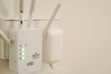 WiFi booster, repeater, or extender on white wall