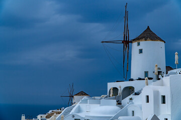 Oia town on Santorini island, Greece. Traditional architecture and famous windmill and white houses...
