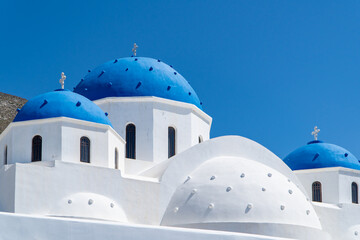 Perissa on Santorini island, Greece. Traditional architecture and famous white church with blue...