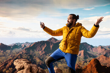 Travel influencer with strong signal live streaming from the mountain top, recording a vlog for his...